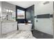 Bright bathroom with a soaking tub next to a window and a glass enclosed shower featuring gray and white tile at 13044 Lakeshore Grove Dr, Winter Garden, FL 34787