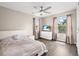 Bright bedroom featuring wood flooring, white dresser, and a ceiling fan at 13044 Lakeshore Grove Dr, Winter Garden, FL 34787