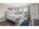 Comfortable bedroom featuring wood flooring, ceiling fan, dresser, bed, and a window at 13044 Lakeshore Grove Dr, Winter Garden, FL 34787