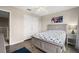 Bright bedroom featuring hardwood floors, ceiling fan, bed and a window at 13044 Lakeshore Grove Dr, Winter Garden, FL 34787