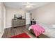 Bedroom with hardwood floors, ceiling fan, dresser, bed and red rug at 13044 Lakeshore Grove Dr, Winter Garden, FL 34787