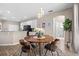 Inviting dining area boasts a modern chandelier, stylish decor, and seamless flow to the kitchen at 13044 Lakeshore Grove Dr, Winter Garden, FL 34787