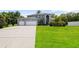 Beautifully landscaped home featuring a spacious driveway and an attached three-car garage at 13044 Lakeshore Grove Dr, Winter Garden, FL 34787