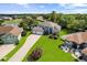 Charming two-story home with manicured lawn, mature trees, and convenient three-car garage at 13044 Lakeshore Grove Dr, Winter Garden, FL 34787