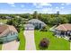 Expansive two-story home featuring a three-car garage, lush lawn, and mature landscaping at 13044 Lakeshore Grove Dr, Winter Garden, FL 34787