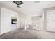 Bright hallway with carpet flooring, white railings, and an open bedroom at 13044 Lakeshore Grove Dr, Winter Garden, FL 34787