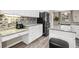 Modern kitchen featuring white cabinets, stainless steel appliances, and mosaic backsplash at 13044 Lakeshore Grove Dr, Winter Garden, FL 34787