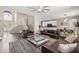 Open concept living room featuring soaring ceilings, a staircase, and hardwood floors at 13044 Lakeshore Grove Dr, Winter Garden, FL 34787
