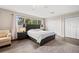 Relaxing main bedroom with wood-look floors, neutral walls, and a large window at 13044 Lakeshore Grove Dr, Winter Garden, FL 34787