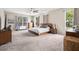 Spacious main bedroom with a ceiling fan, treadmill, and great natural light at 13044 Lakeshore Grove Dr, Winter Garden, FL 34787