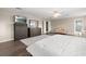 Spacious main bedroom with wood floors, ensuite bath, sitting area, and dual dresser storage at 13044 Lakeshore Grove Dr, Winter Garden, FL 34787