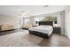 Inviting main bedroom with wood-look floors, neutral walls, and a seating area at 13044 Lakeshore Grove Dr, Winter Garden, FL 34787