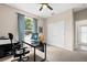 Home office featuring a ceiling fan, large window with peaceful views, and a closet at 13044 Lakeshore Grove Dr, Winter Garden, FL 34787