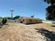 Expansive backyard with privacy fence, offering a tranquil retreat with city views in the distance at 1419 Avenue D Ne, Winter Haven, FL 33881