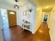 Inviting foyer featuring a wood door, hardwood floors, and decor, creating a warm and welcoming entry at 1419 Avenue D Ne, Winter Haven, FL 33881