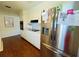 Practical kitchen showcasing white cabinets, modern stainless steel refrigerator, and built-in oven at 1419 Avenue D Ne, Winter Haven, FL 33881