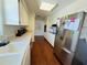 Well-lit kitchen featuring white cabinets, stainless steel refrigerator, and long countertops at 1419 Avenue D Ne, Winter Haven, FL 33881