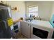 Functional laundry room featuring a modern washer and dryer set and practical shelving at 1419 Avenue D Ne, Winter Haven, FL 33881