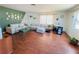Comfortable living room showcasing a spacious sectional, wood floors, and a bright window illuminating the space at 1419 Avenue D Ne, Winter Haven, FL 33881
