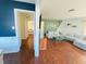 Open-concept living room featuring a large sectional, wood floors, and a unique two-tone accent wall design at 1419 Avenue D Ne, Winter Haven, FL 33881