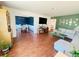 Cozy living room featuring wood floors, a modern sectional, and a unique green accent wall with decorative artwork at 1419 Avenue D Ne, Winter Haven, FL 33881