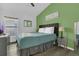 Comfortable bedroom with a ceiling fan, wood-look floors, a color accent wall, and natural light at 147 Bridgewater Dr, Davenport, FL 33897