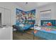 bedroom with two twin beds, a closet, wood-look floors, and colorful Marvel themed wallpaper at 147 Bridgewater Dr, Davenport, FL 33897