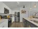 Bright kitchen with white cabinets, stainless steel appliances, and a center island with seating at 147 Bridgewater Dr, Davenport, FL 33897