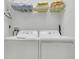 Convenient laundry room with a washer and dryer and shelving for storage at 147 Bridgewater Dr, Davenport, FL 33897
