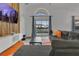Inviting living room with sliding glass doors to the pool, a wooden accent wall, and a comfortable seating area at 147 Bridgewater Dr, Davenport, FL 33897
