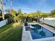 Tranquil backyard with a pristine pool, lush landscaping, and a secure privacy fence at 14963 Yorkshire Run Dr, Orlando, FL 32828