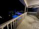 Night view from the balcony overlooking the illuminated pool and landscaped backyard at 14963 Yorkshire Run Dr, Orlando, FL 32828
