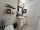 This is a well-lit bathroom with shelves, a vanity, a sink, and a mirror at 14963 Yorkshire Run Dr, Orlando, FL 32828