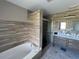 Elegant bathroom features a soaking tub, glass enclosed shower, and double sink vanity at 14963 Yorkshire Run Dr, Orlando, FL 32828