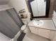 This is a well-lit bathroom with shelves, a vanity, a sink, and a mirror at 14963 Yorkshire Run Dr, Orlando, FL 32828