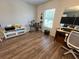 This bedroom offers natural light from the window and stylish wood-look vinyl floors at 14963 Yorkshire Run Dr, Orlando, FL 32828