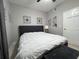 Neutral bedroom featuring a black headboard, fan, and light gray walls offering a serene and simple space at 14963 Yorkshire Run Dr, Orlando, FL 32828