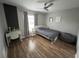 Bright bedroom with hardwood floors, a comfortable bed, and ample space for a desk at 14963 Yorkshire Run Dr, Orlando, FL 32828