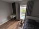 Well-lit bedroom featuring a desk, a comfortable bed, and view of the pool at 14963 Yorkshire Run Dr, Orlando, FL 32828