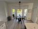 Bright breakfast nook with bay window, modern lighting, and view of the pool at 14963 Yorkshire Run Dr, Orlando, FL 32828