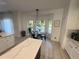 Bright dining area with large windows overlooking the pool, complemented by white cabinets at 14963 Yorkshire Run Dr, Orlando, FL 32828