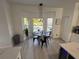 Cozy dining area with a bay window overlooking the pool, adjacent to the modern kitchen at 14963 Yorkshire Run Dr, Orlando, FL 32828