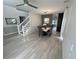 Open-concept dining area featuring a contemporary table set and overhead lighting with view to the staircase at 14963 Yorkshire Run Dr, Orlando, FL 32828