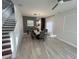 Open-concept dining area featuring a contemporary table set and overhead lighting with view to the staircase at 14963 Yorkshire Run Dr, Orlando, FL 32828