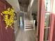 Inviting foyer with a staircase and a yellow floral wreath on the front door, with views of the living areas beyond at 14963 Yorkshire Run Dr, Orlando, FL 32828