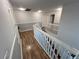 Bright hallway with wood floors, white trim, and staircase at 14963 Yorkshire Run Dr, Orlando, FL 32828