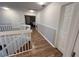 Second floor hallway with wood floors leading to bedroom at 14963 Yorkshire Run Dr, Orlando, FL 32828