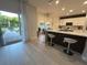 Stylish kitchen with stainless steel appliances, island seating, and an open view to the backyard at 14963 Yorkshire Run Dr, Orlando, FL 32828