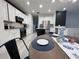 Bright, open kitchen with modern white cabinets, stainless appliances, and adjacent breakfast nook at 14963 Yorkshire Run Dr, Orlando, FL 32828