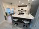 Bright, open kitchen with modern white cabinets, a large island, and stylish bar stool seating at 14963 Yorkshire Run Dr, Orlando, FL 32828